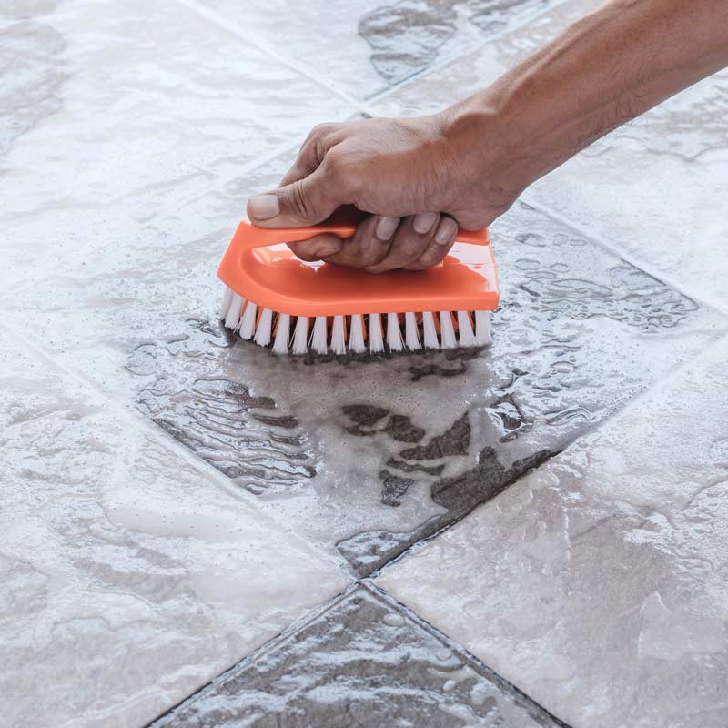 Professional cleaning of tile flooring with a brush in Phoenix, AZ