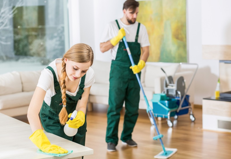 Home cleaning shown by professionals in Phoenix, AZ, includes wiping surfaces & mopping floors