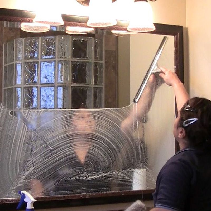 An expert cleaner is polishing the window surface during glass cleaning in Phoenix, AZ
