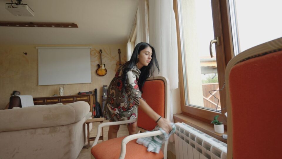 housekeeper cleaning armchair cloth